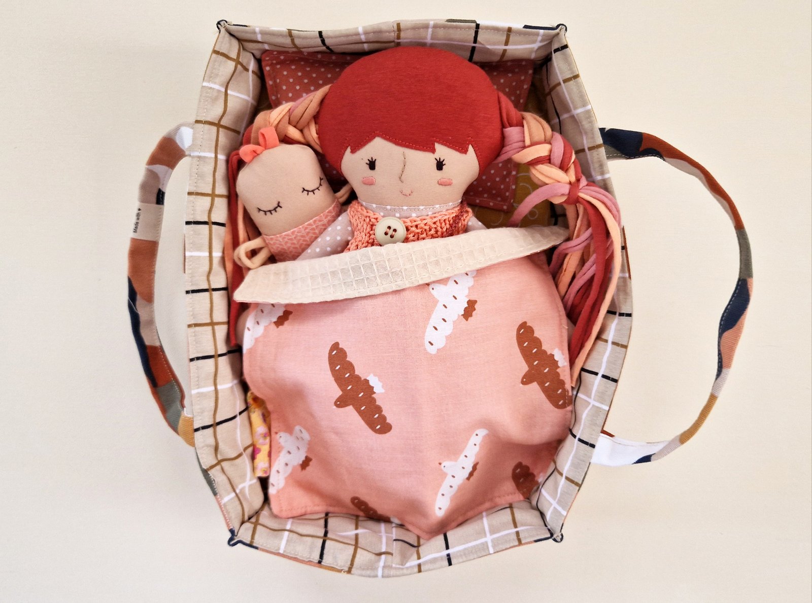 Soft cloth doll with long colorful fabric hair and a set of changeable outfits