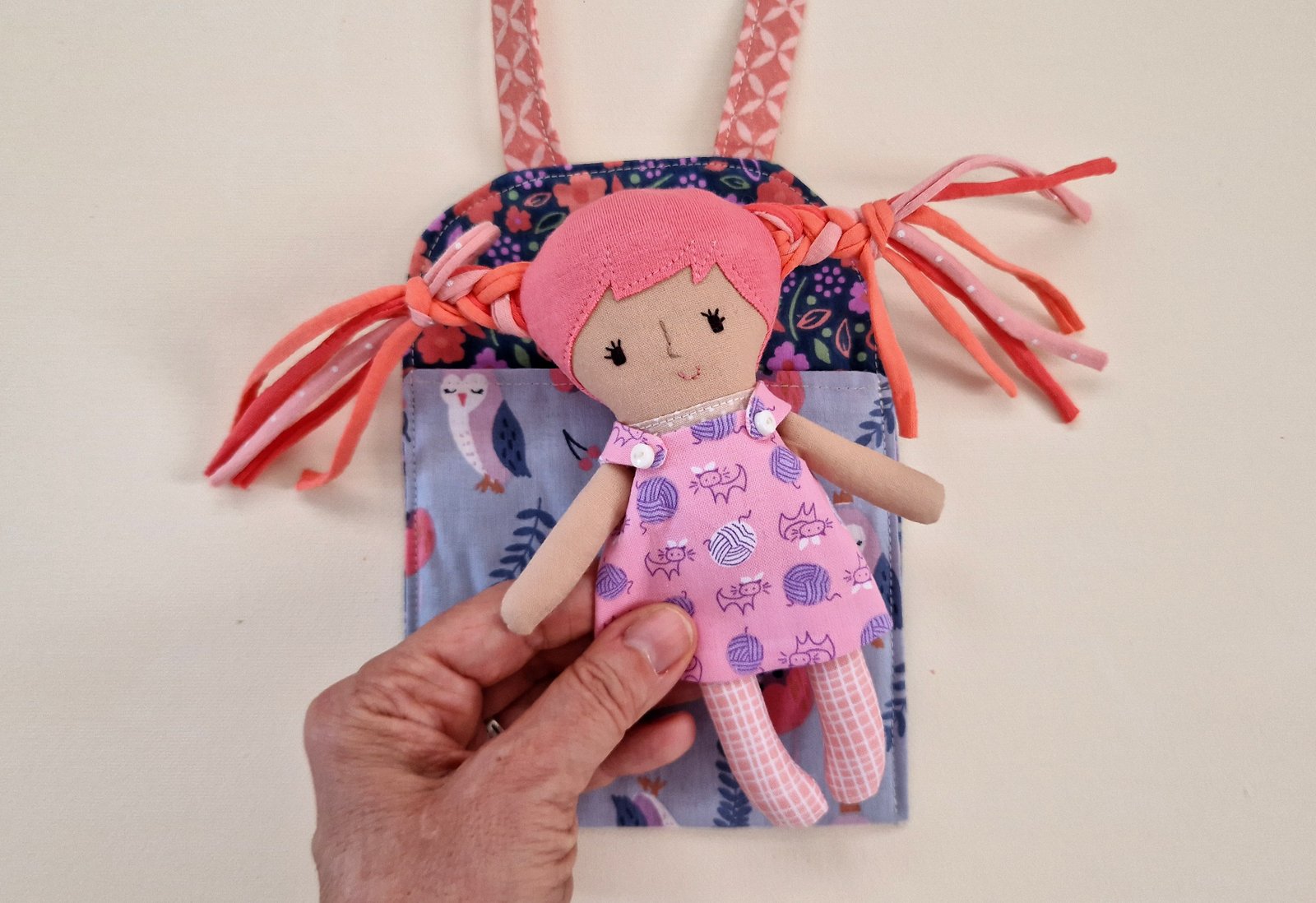 Colorful mini bag with a fabric doll for children
