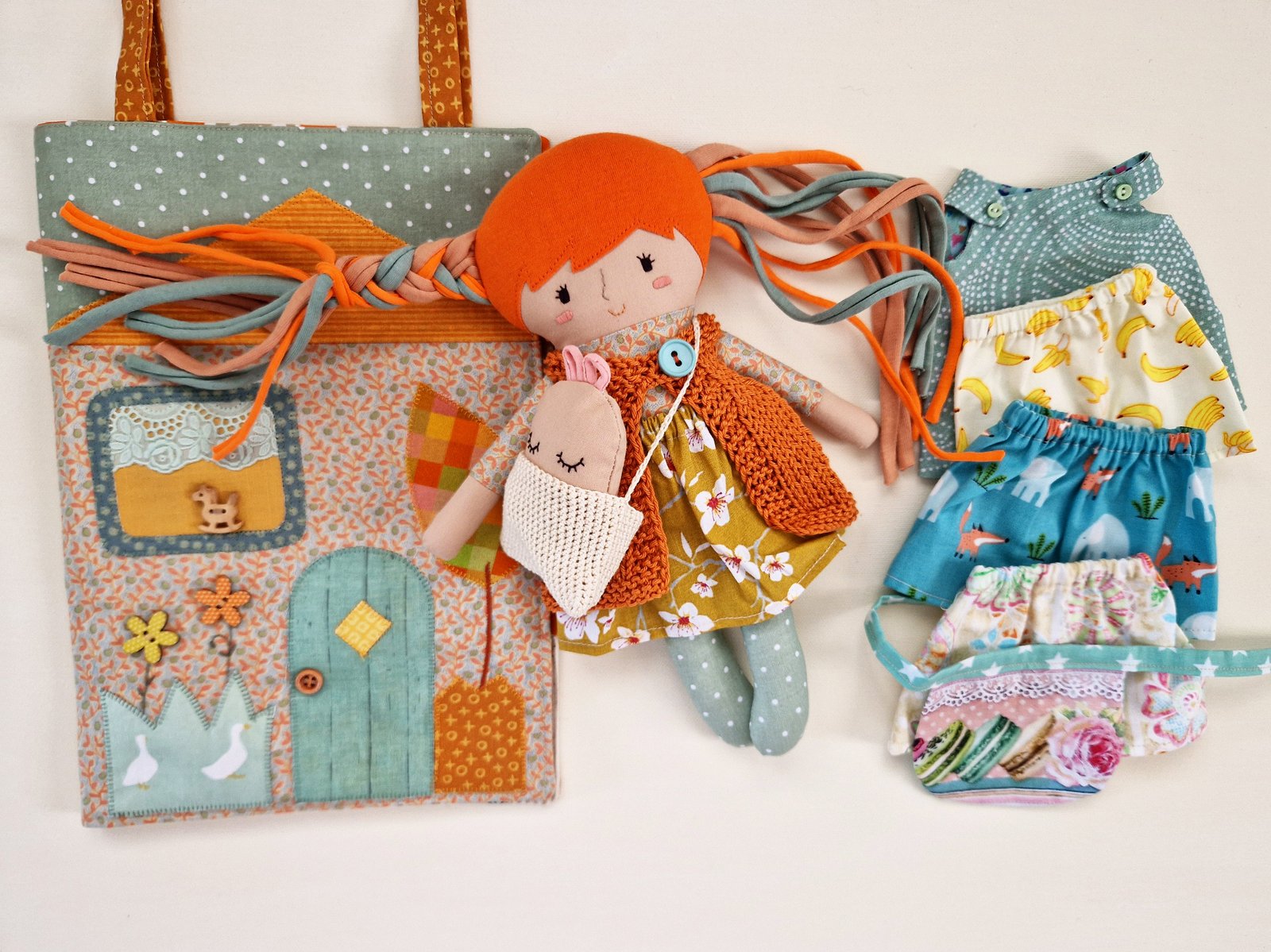 Children's activity set with a doll and a house that becomes a bag
