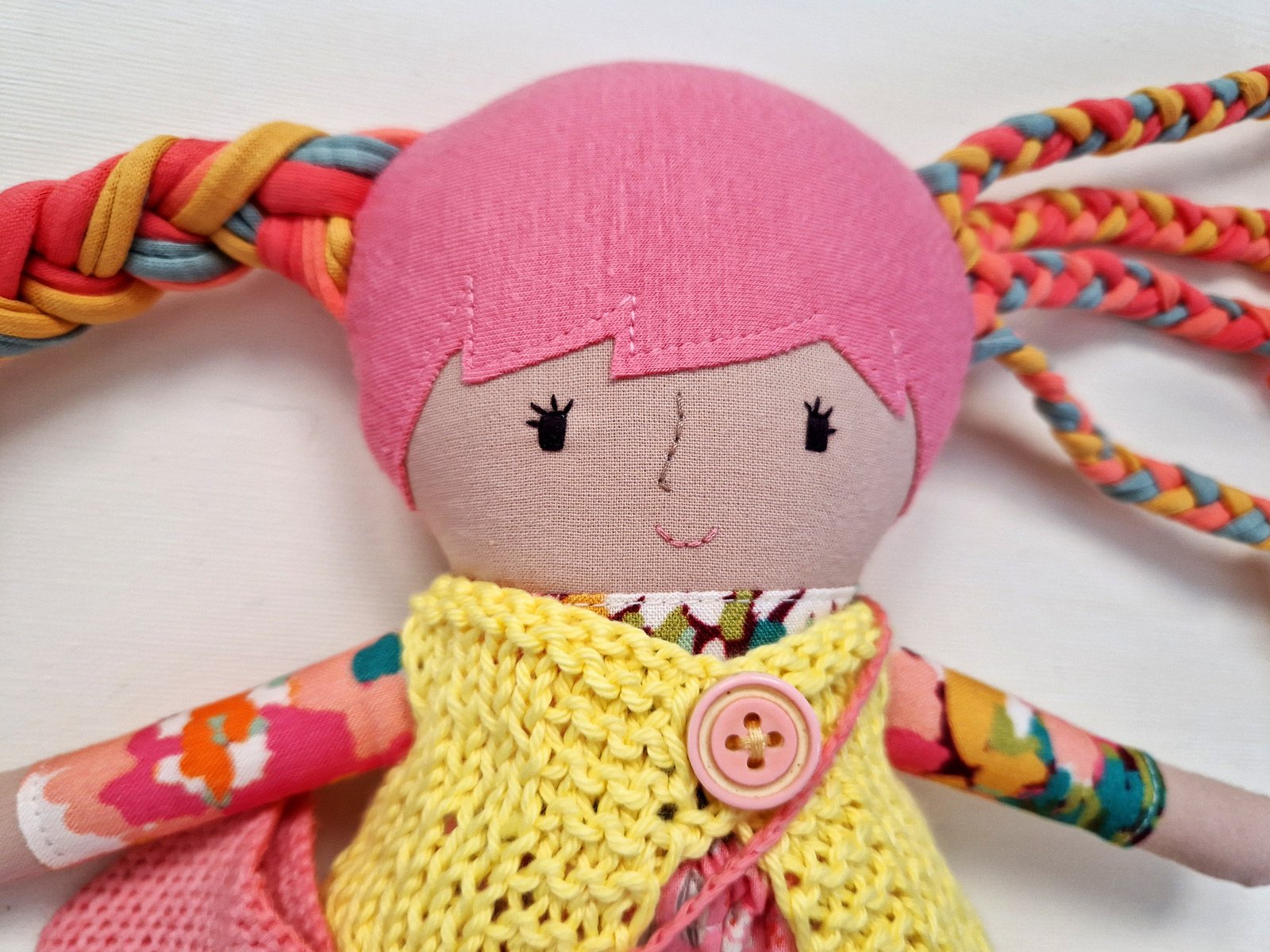 Play doll with a colorful dress, small bag, and an additional interchangeable skirt.