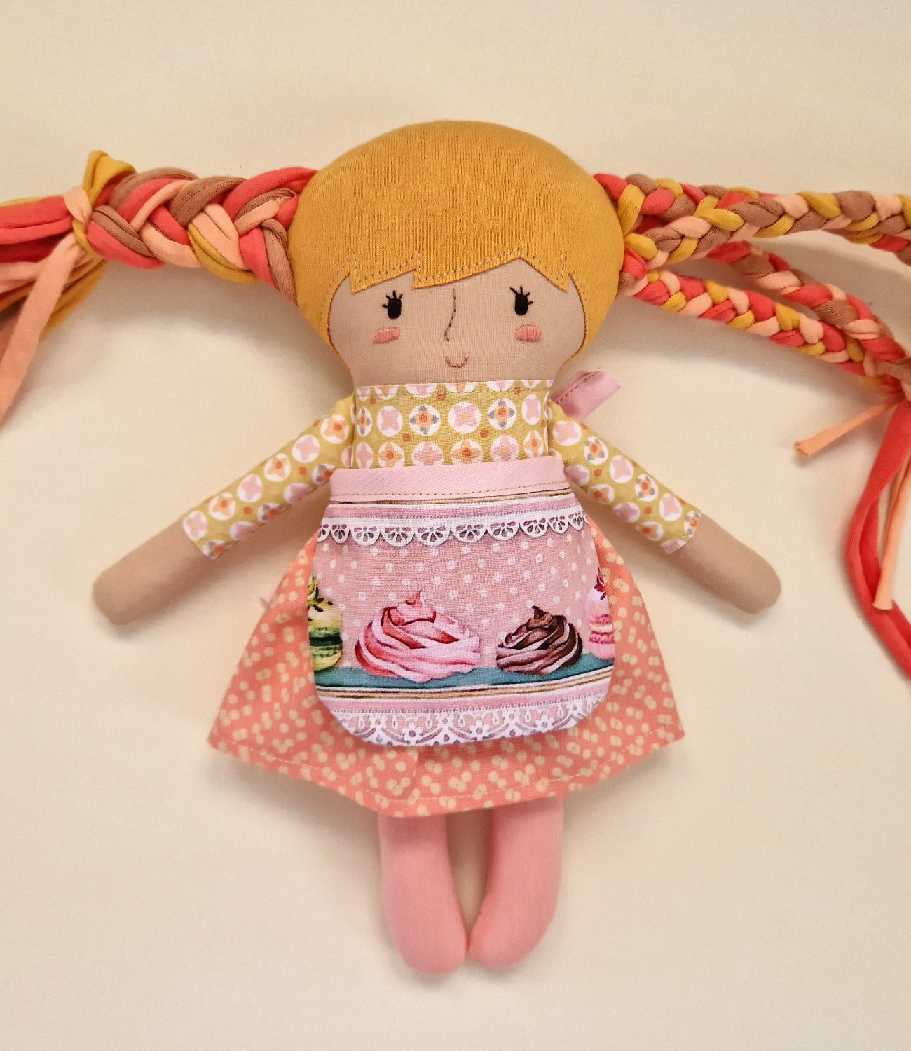 Colorful play doll with long hair and a fabric baby doll accessory.