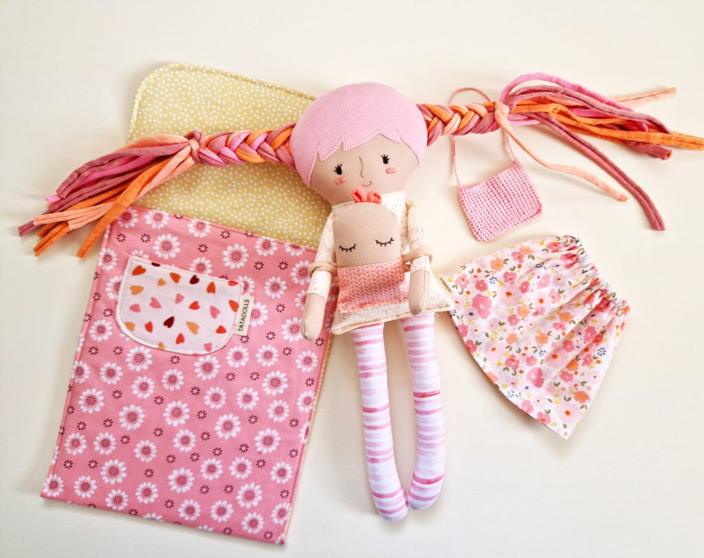 Dress up doll with baby in sleeping bag