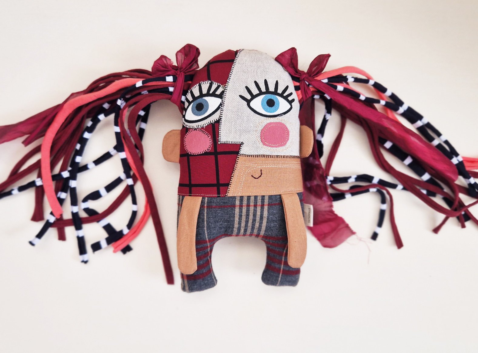 Original artistic fabric doll with large eyes, patterned clothing, and colorful handmade hair.