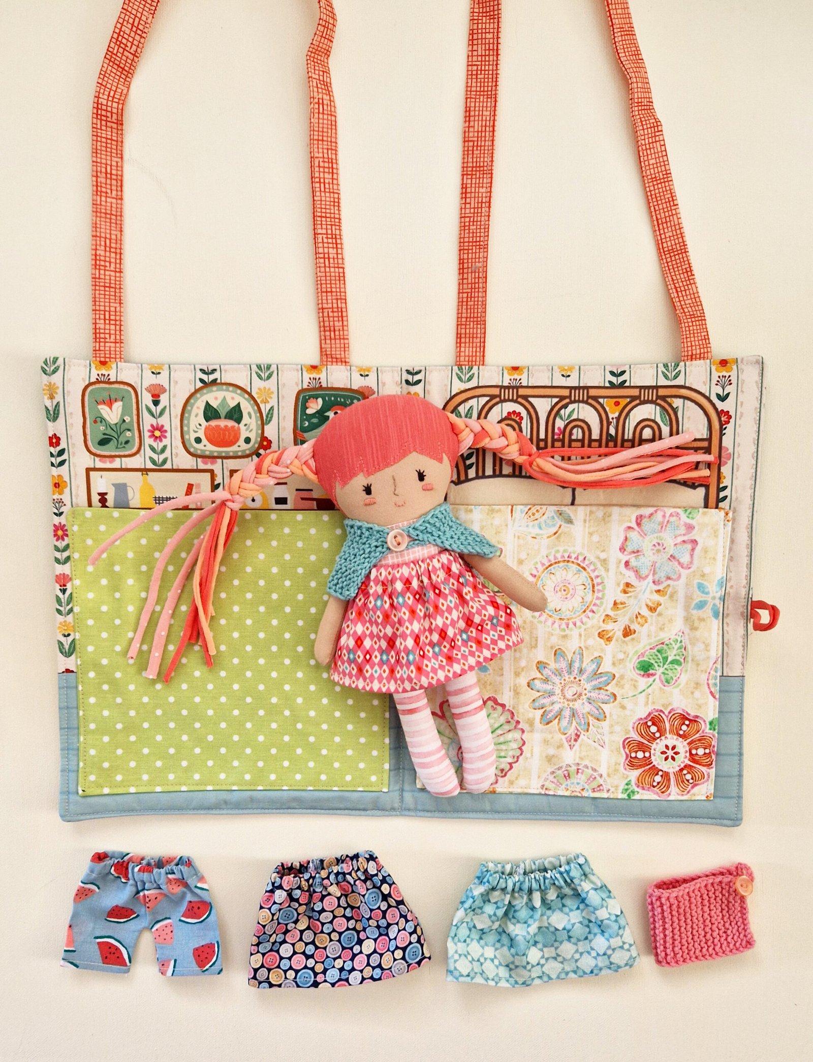 Developmental doll with a house bag and interchangeable clothes