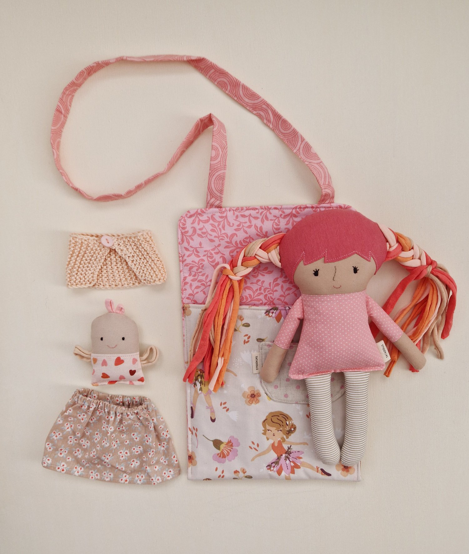 Soft fabric doll with a small toy, clothes and carrying bag