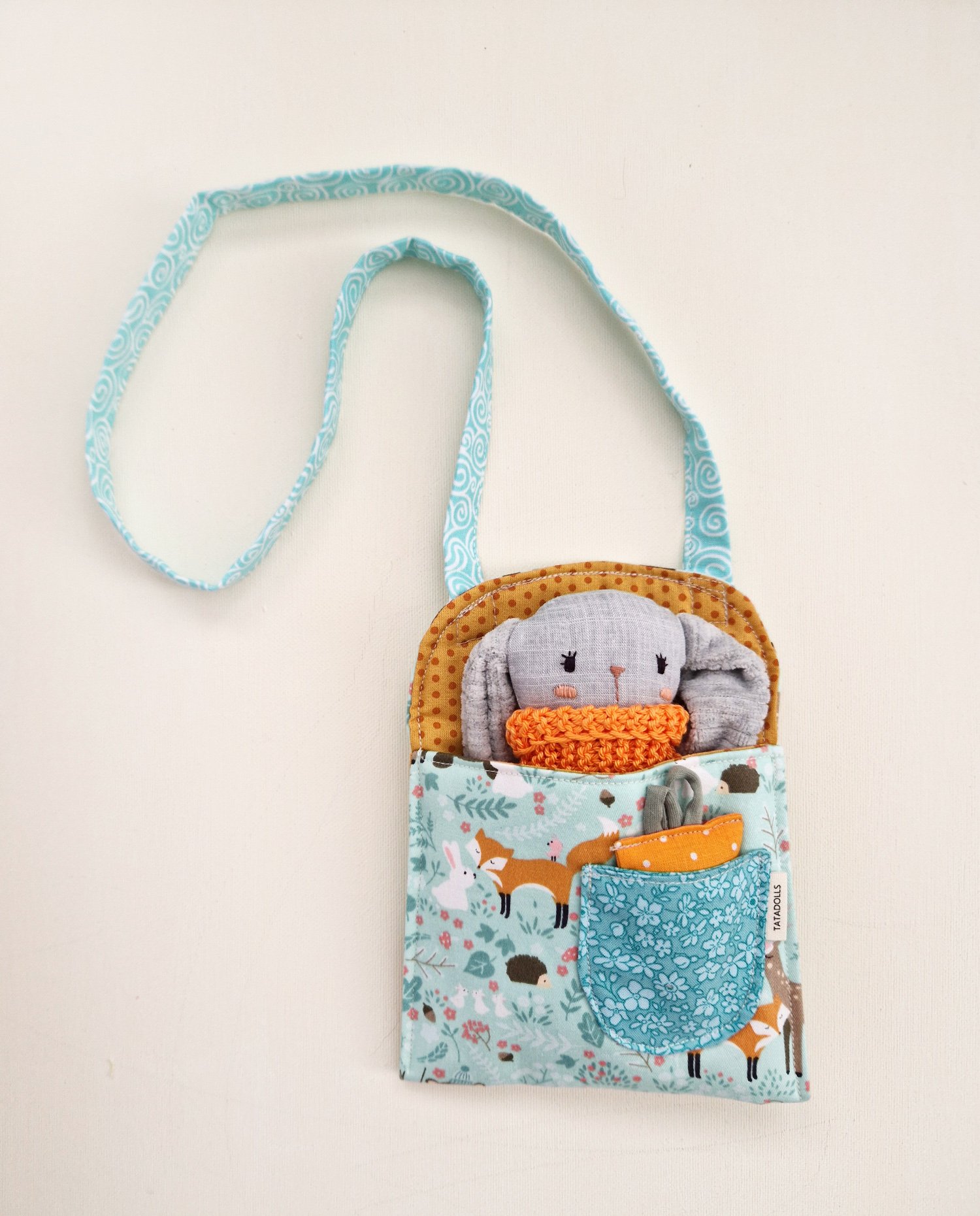 Small fabric bag with a bunny toy and carrot accessory