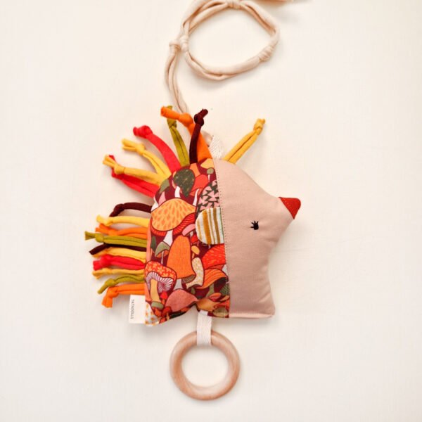 Double-sided fabric hedgehog rattle with colorful floral print and wooden teething ring