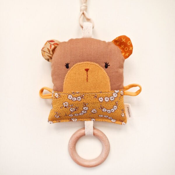 Double-sided fabric bear rattle with floral pocket and wooden teething ring