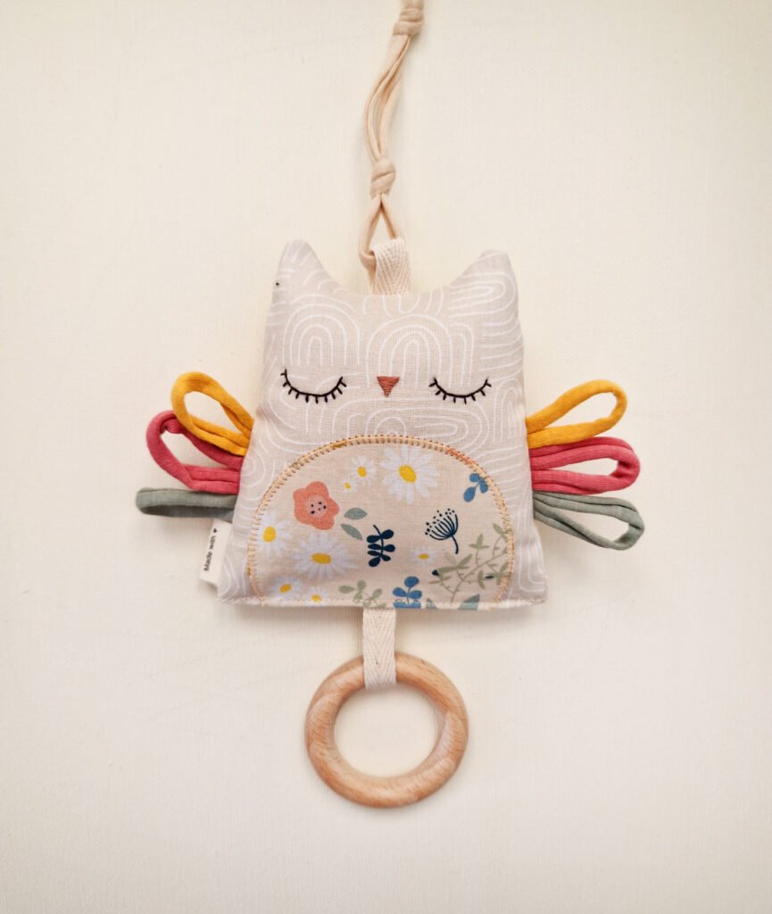 Double-sided baby owl toy with colorful ribbons and wooden teething ring