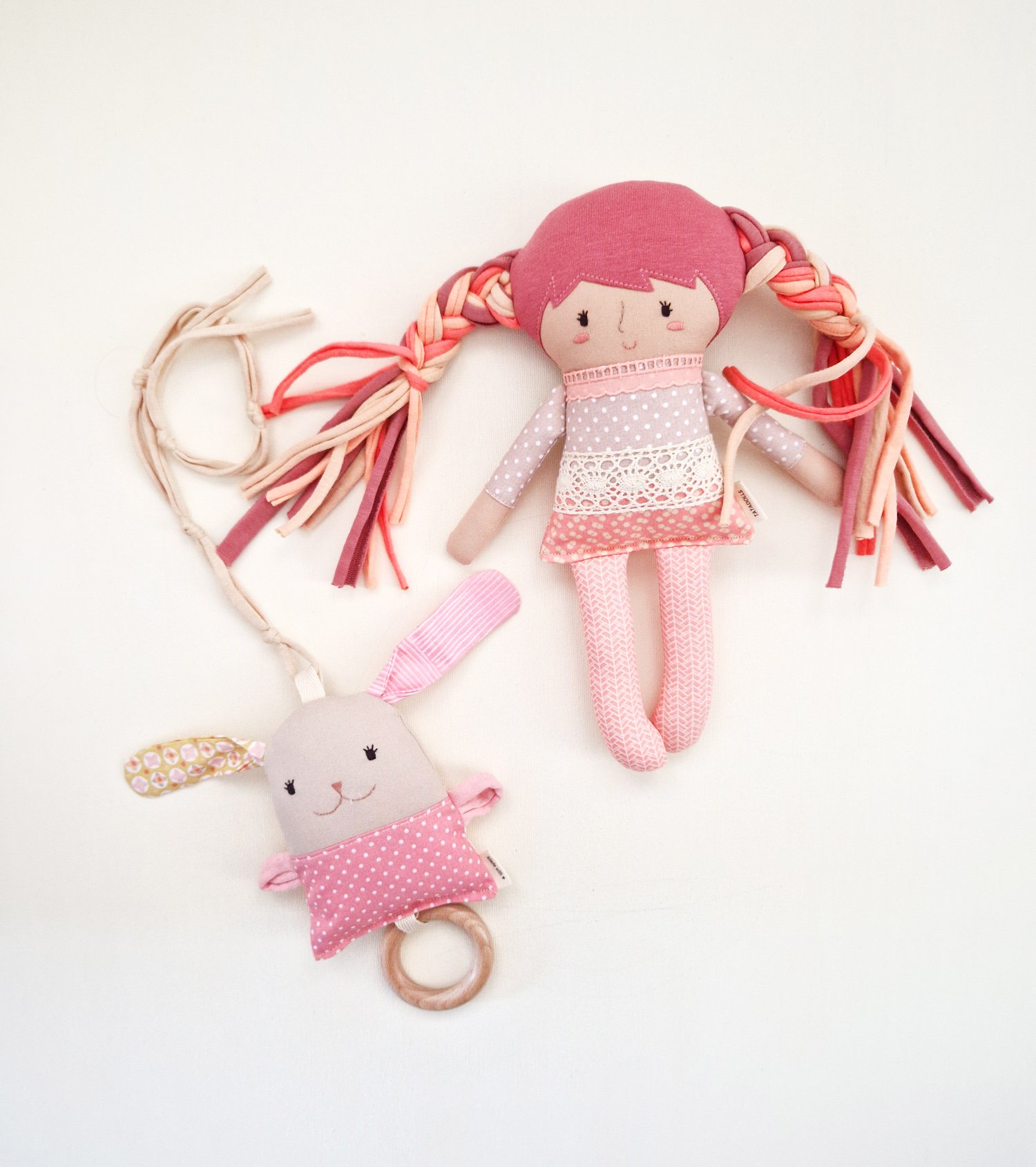 Baby sensory play set featuring a fabric doll and rattle with wooden teething ring