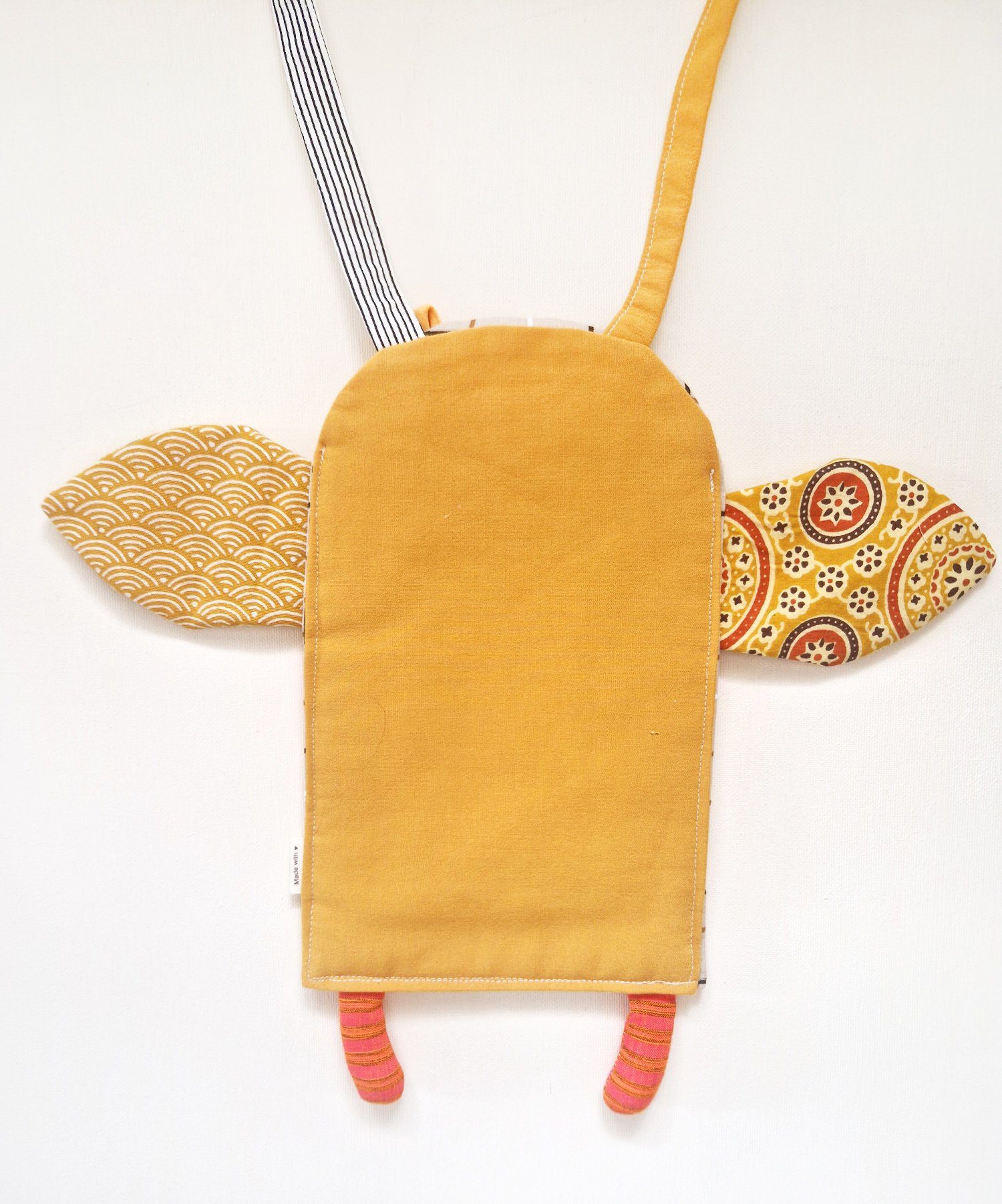 Handmade textile bag with patterned fabric, colorful striped legs and long shoulder strap
