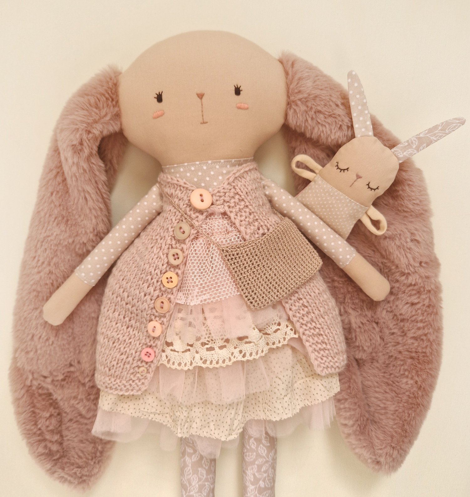 Handmade rabbit mother doll with long soft ears and baby bunny on a swing