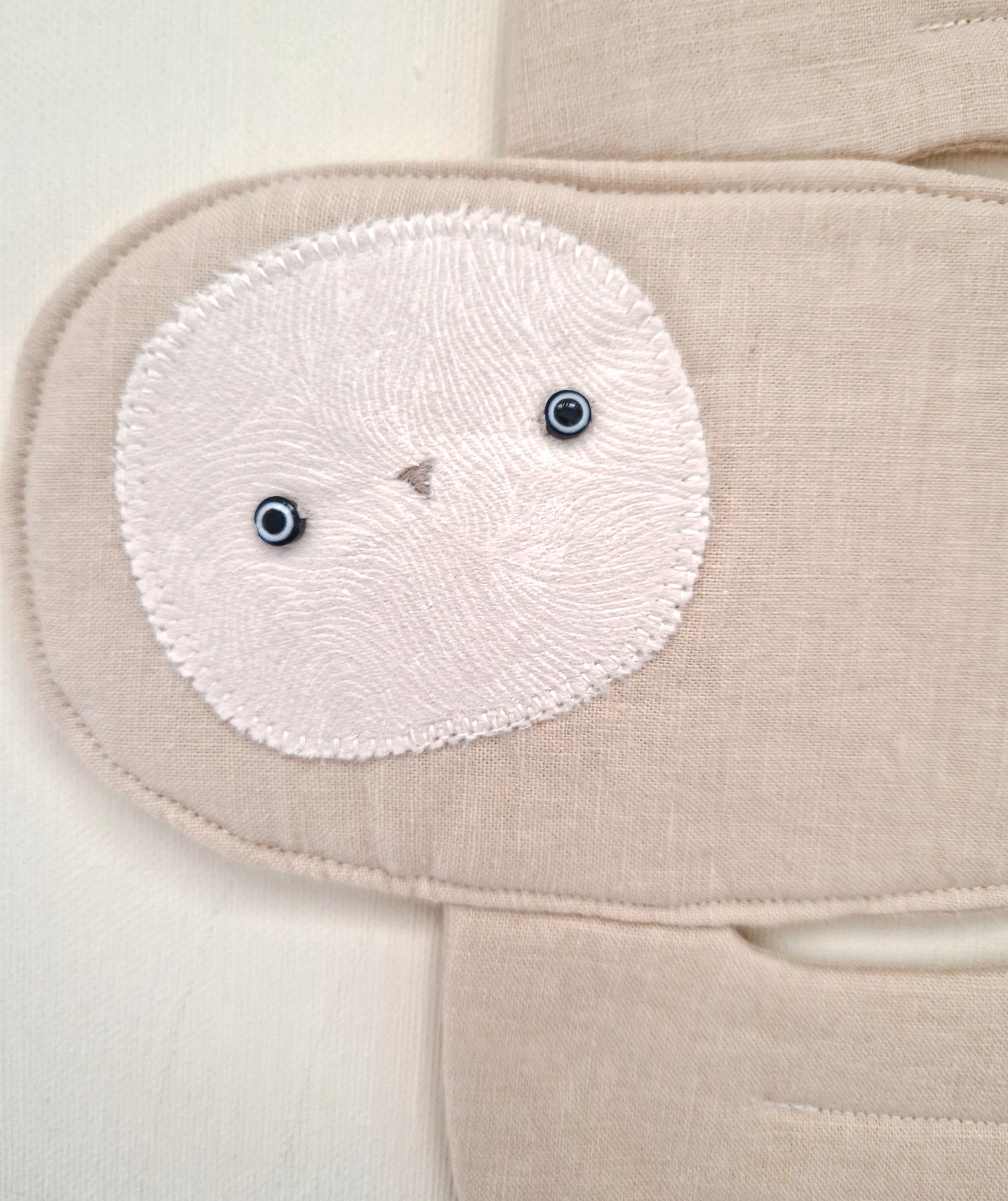 Handmade white boho owl wall hanging made from natural fabric with delicate lace details