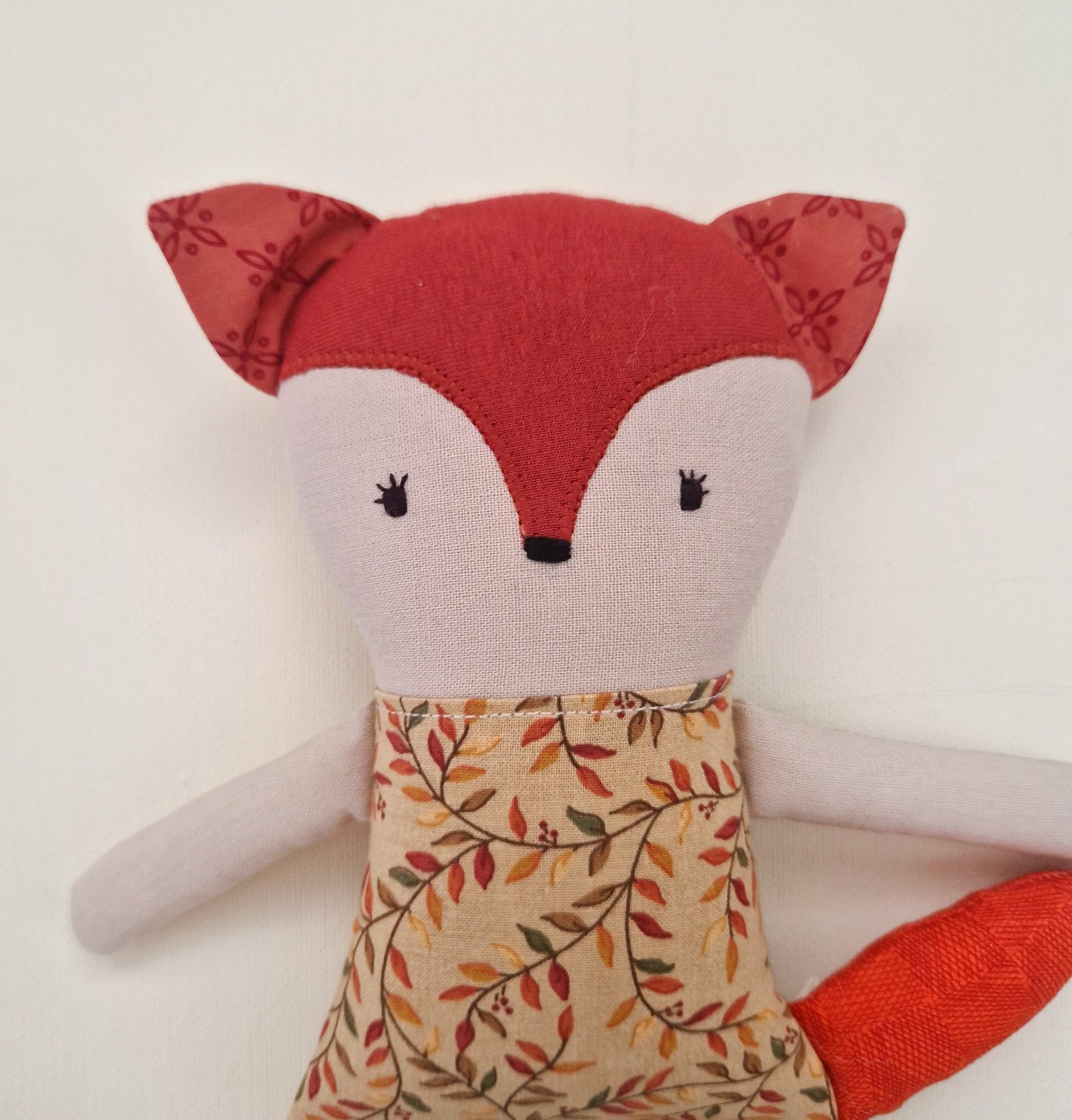 Handmade fabric fox doll with a floral dress and red tail