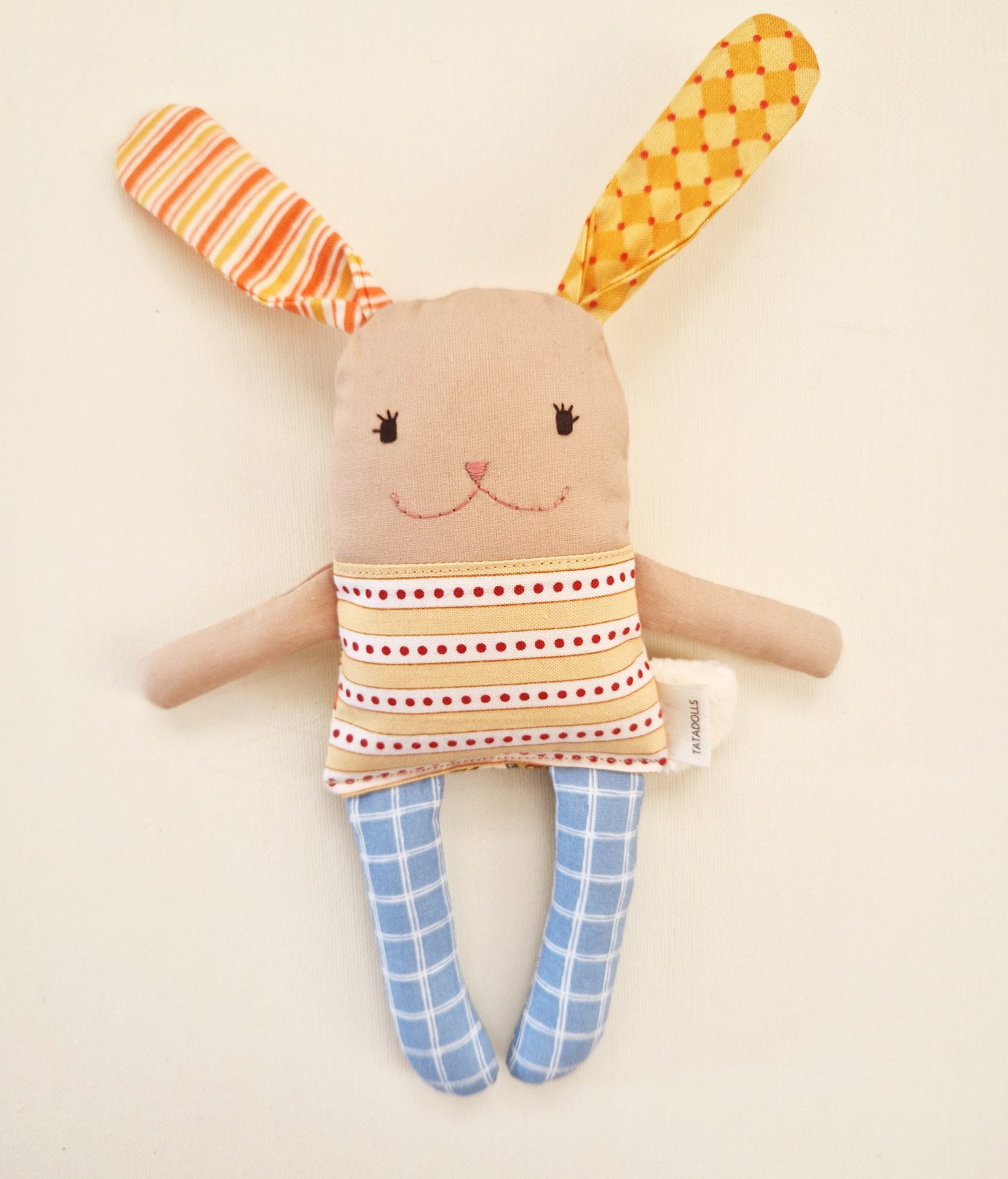 Reversible fabric bunny doll for babies, shown with its two different sides