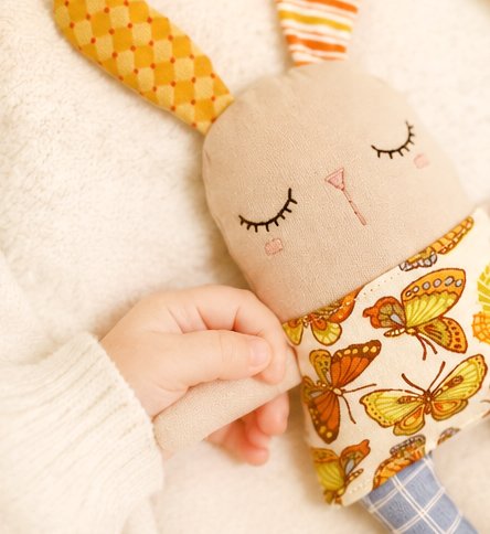 Cute handmade bunny comfort toy with soft fabric and colorful details
