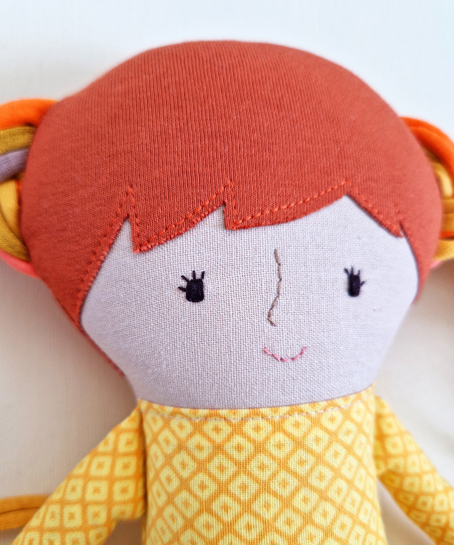 Handmade textile doll with long colorful yarn hair and matching accessories