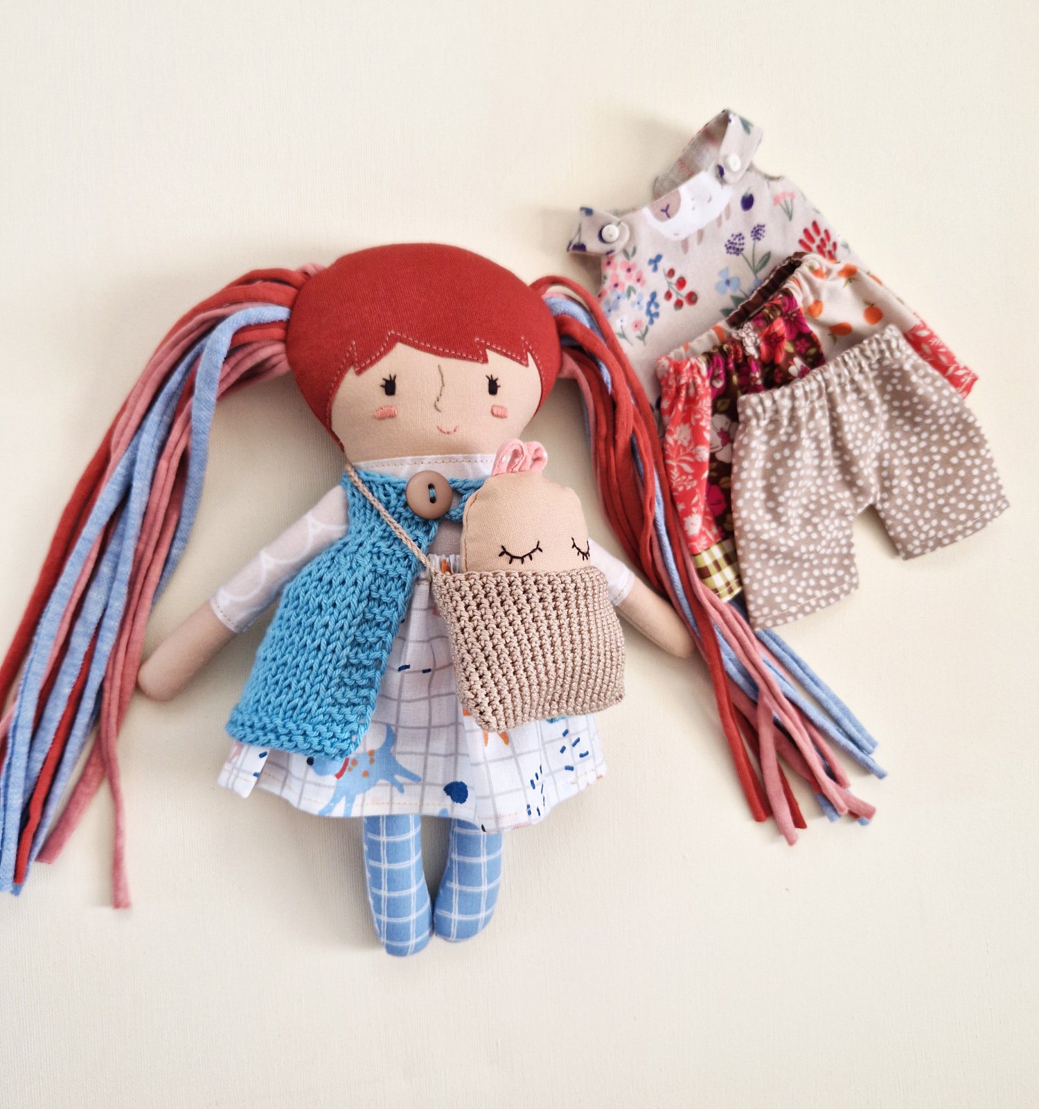 Cloth rag doll with red yarn hair and mix and match wardrobe outfits