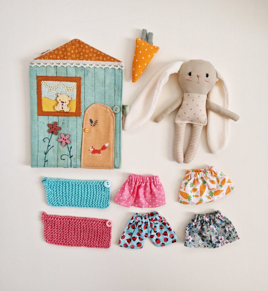 Handmade textile bunny pocket house play set with a removable wardrobe