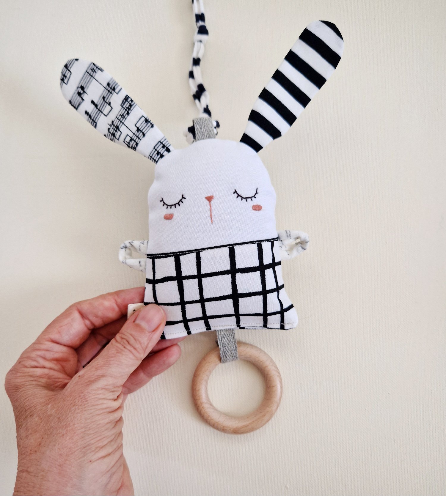 Handmade black and white two-sided bunny rattle with wooden ring