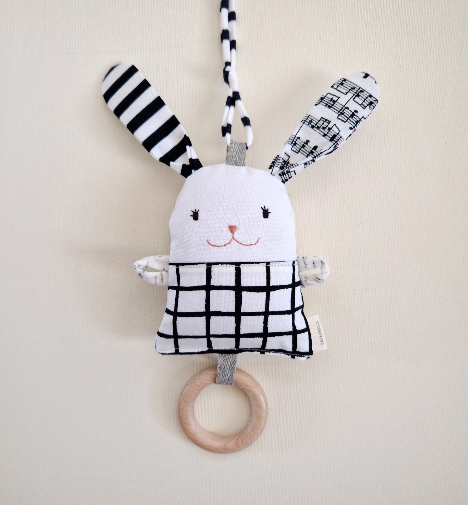 Black and white fabric bunny baby rattle with long ears and wooden teething ring